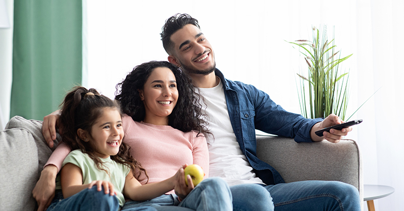 happy family sitting in their home together