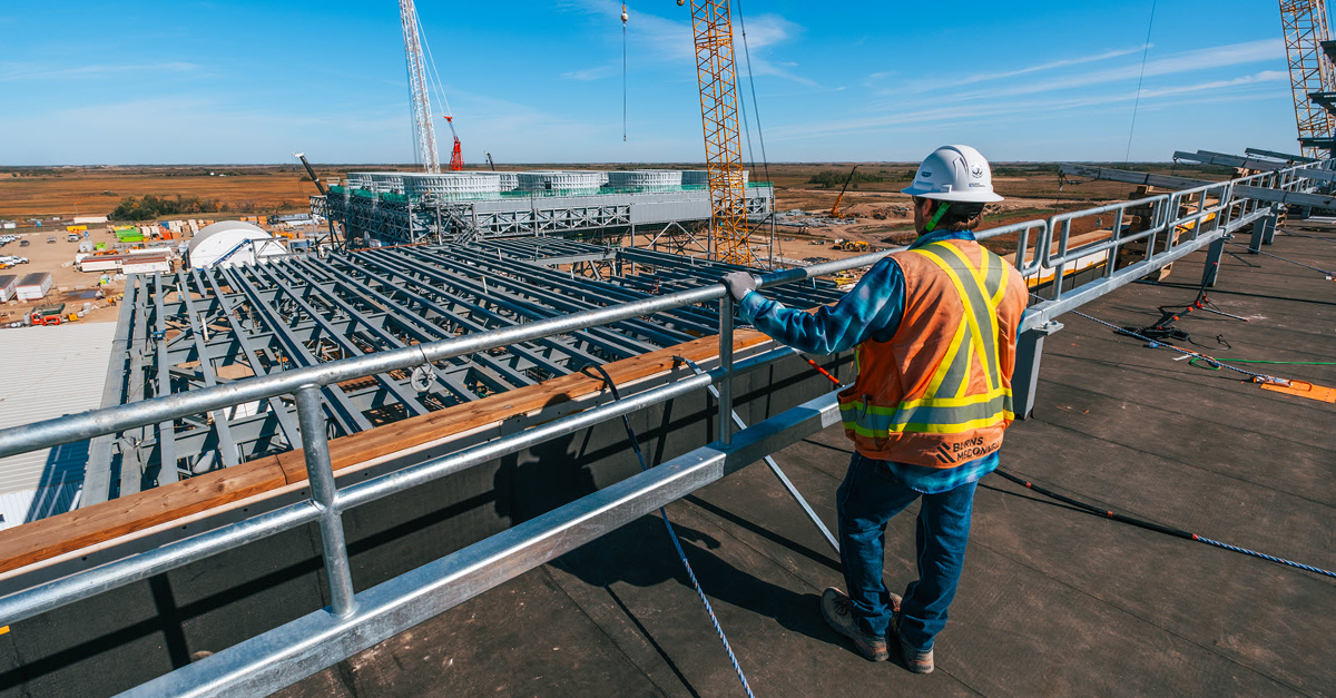 construction worker overlooking a facility