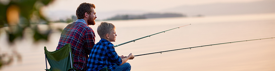 Father and sun fishing on a lake.